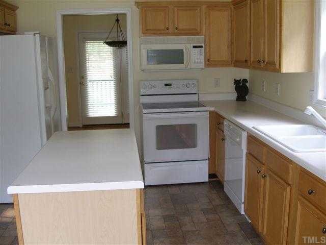 1102 Bahama Road Bahama, NC 27503 - Photo 6 of 8 a kitchen with granite countertop a sink a stove and cabinets