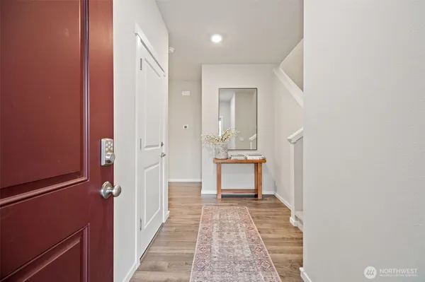 a view of a room with wooden floor and a bathroom
