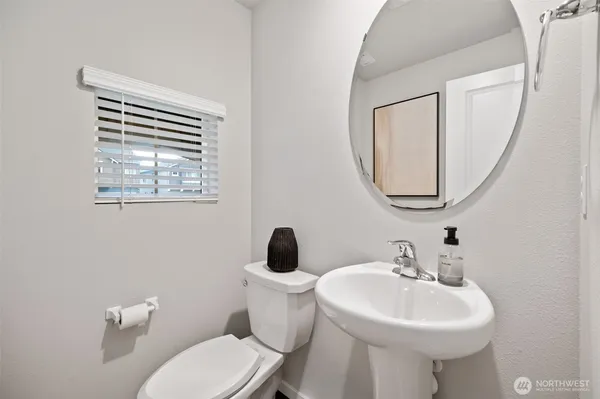 a bathroom with a sink a mirror and a toilet