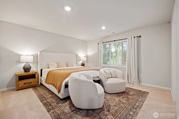 a bedroom with a bed and a couch