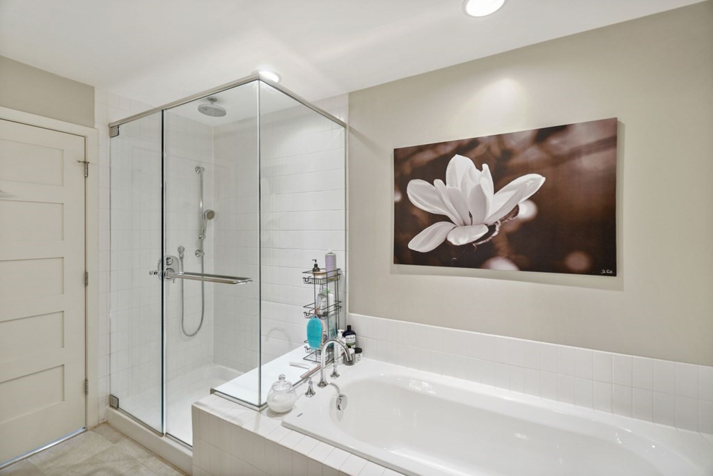 1245 Adams Street, Unit B210 Boston, MA 02124 - Photo 11 of 23 a bathroom with a bathtub and a shower