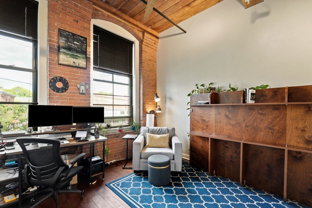 1245 Adams Street, Unit B210 Boston, MA 02124 - Photo 12 of 23 a living room with furniture and a flat screen tv