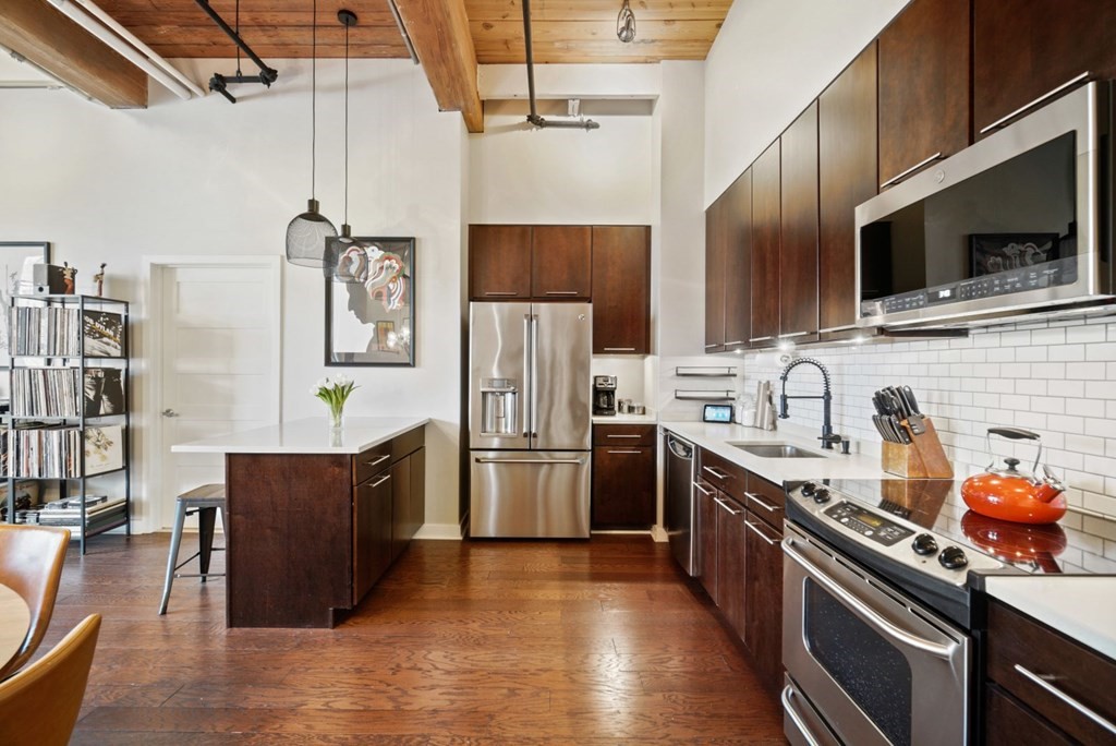 1245 Adams Street, Unit B210 Boston, MA 02124 - Photo 2 of 23 a kitchen with stainless steel appliances a stove a sink dishwasher a refrigerator and a microwave
