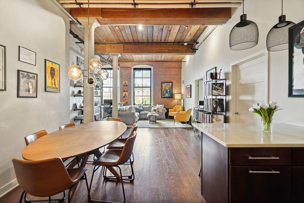 1245 Adams Street, Unit B210 Boston, MA 02124 - Photo 3 of 23 a view of a dining room with furniture and chandelier