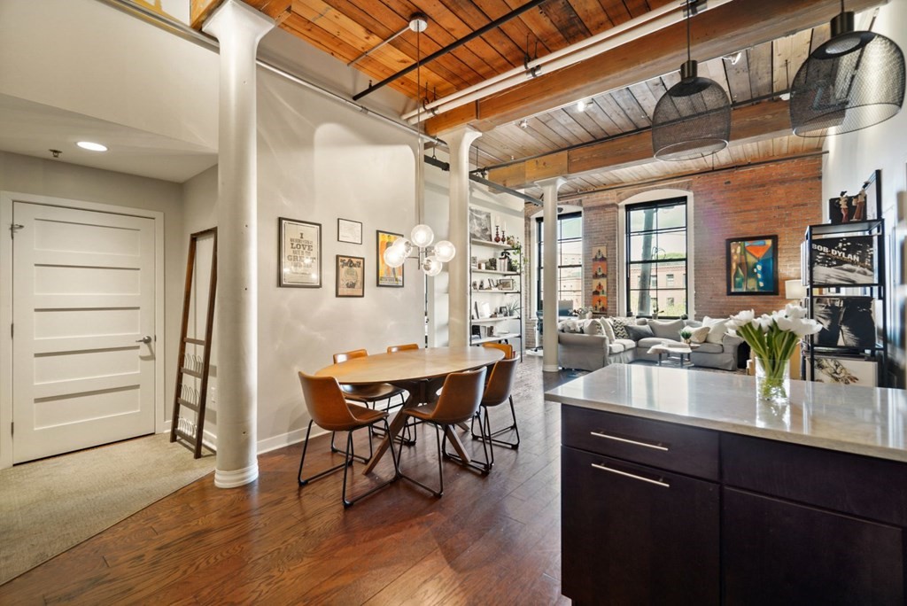 1245 Adams Street, Unit B210 Boston, MA 02124 - Photo 4 of 23 a dining hall with stainless steel appliances granite countertop a sink and wooden floors