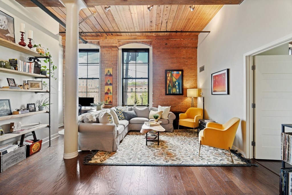 1245 Adams Street, Unit B210 Boston, MA 02124 - Photo 6 of 23 a living room with furniture and a wooden floor