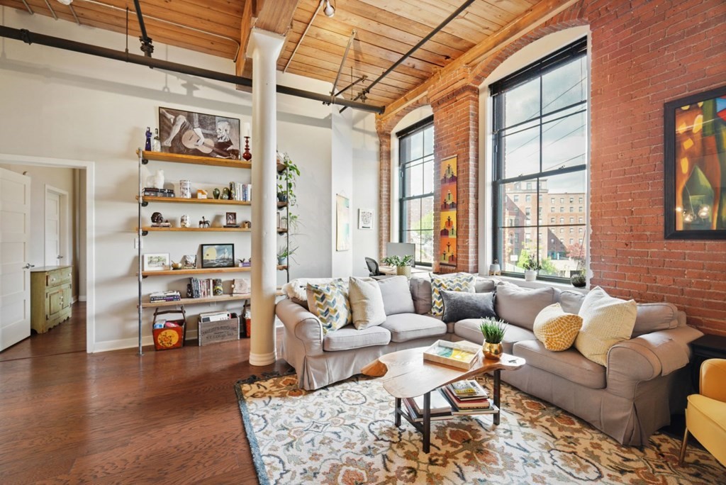 1245 Adams Street, Unit B210 Boston, MA 02124 - Photo 7 of 23 a living room with furniture and a large window