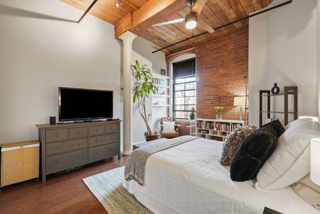 1245 Adams Street, Unit B210 Boston, MA 02124 - Photo 8 of 23 a bedroom with a bed and a flat screen tv