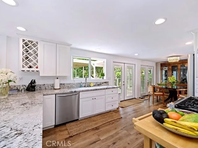 a kitchen with a sink a stove and cabinets