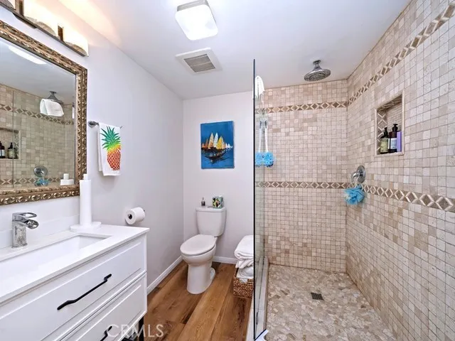 a bathroom with a sink a toilet and shower
