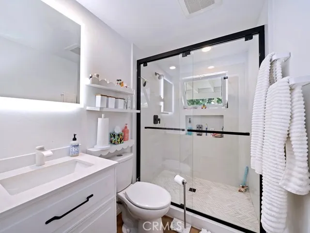 a bathroom with a sink toilet and shower