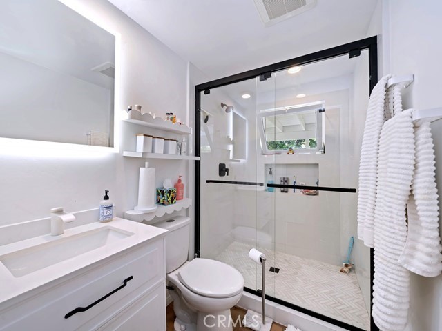 1570 Burgundy Road Encinitas, CA 92024 - Photo 22 of 47 a bathroom with a sink toilet and shower