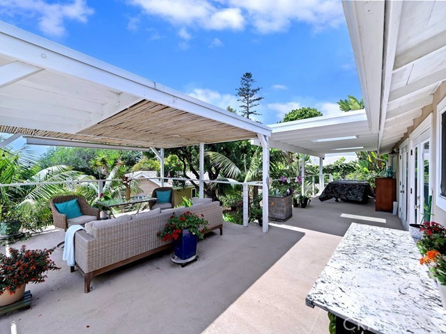 1570 Burgundy Road Encinitas, CA 92024 - Photo 23 of 47 a view of a patio with table and chairs under an umbrella