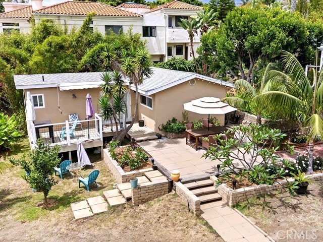 1570 Burgundy Road Encinitas, CA 92024 - Photo 34 of 47 a view of a patio with table and chairs and potted plants