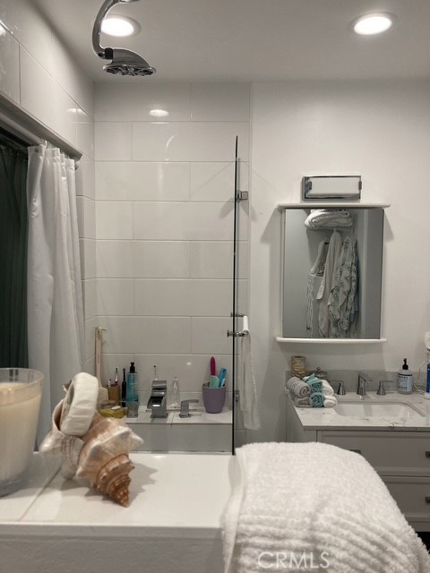 1570 Burgundy Road Encinitas, CA 92024 - Photo 39 of 47 a bathroom with a tub sink and mirror