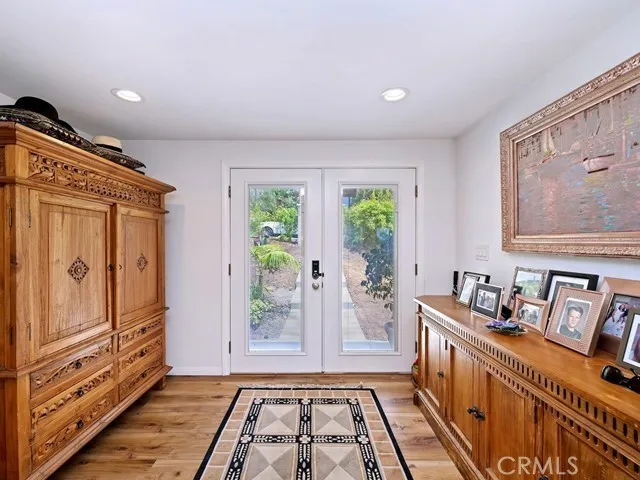 a kitchen with stainless steel appliances granite countertop a stove a sink and a refrigerator with wooden floor