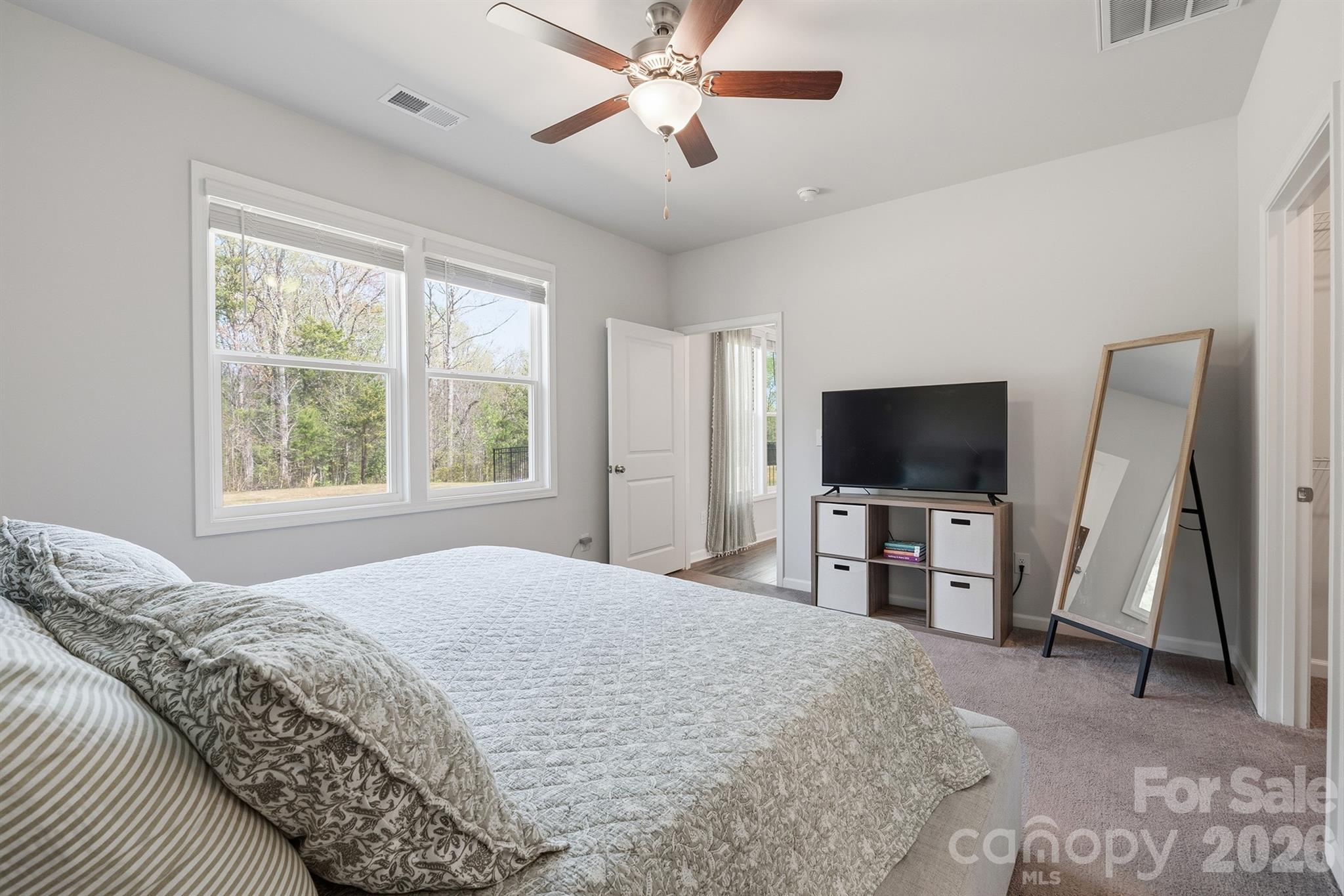 8220 Mccormick Street Terrell, NC 28682 - Photo 16 of 33 a bedroom with a bed and a flat tv screen on the dresser