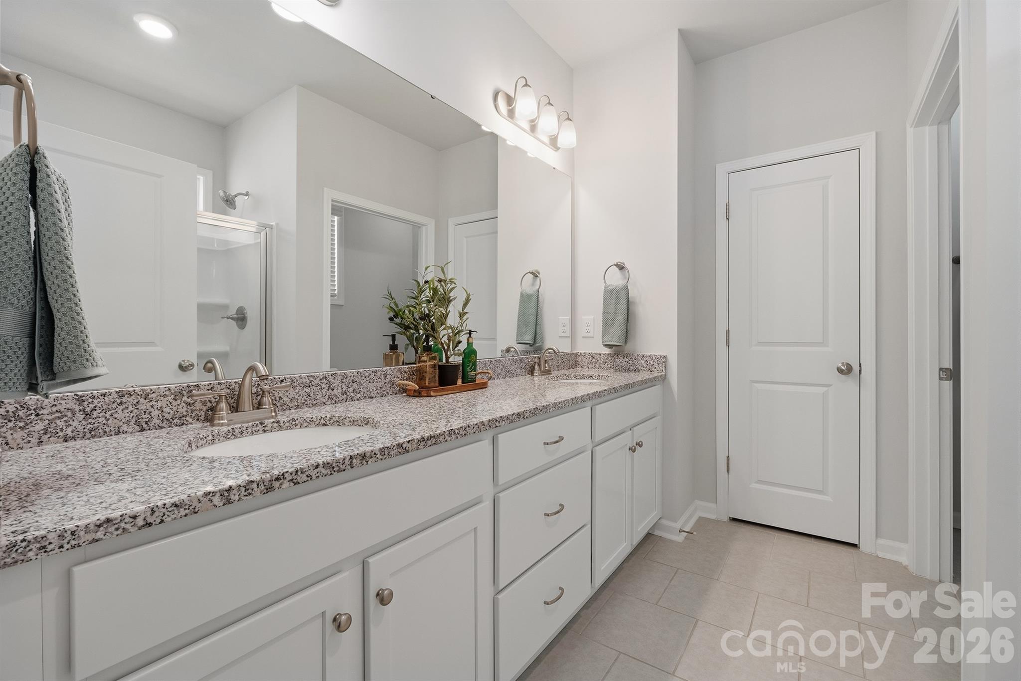 8220 Mccormick Street Terrell, NC 28682 - Photo 18 of 33 a bathroom with a granite countertop double vanity sink and a mirror