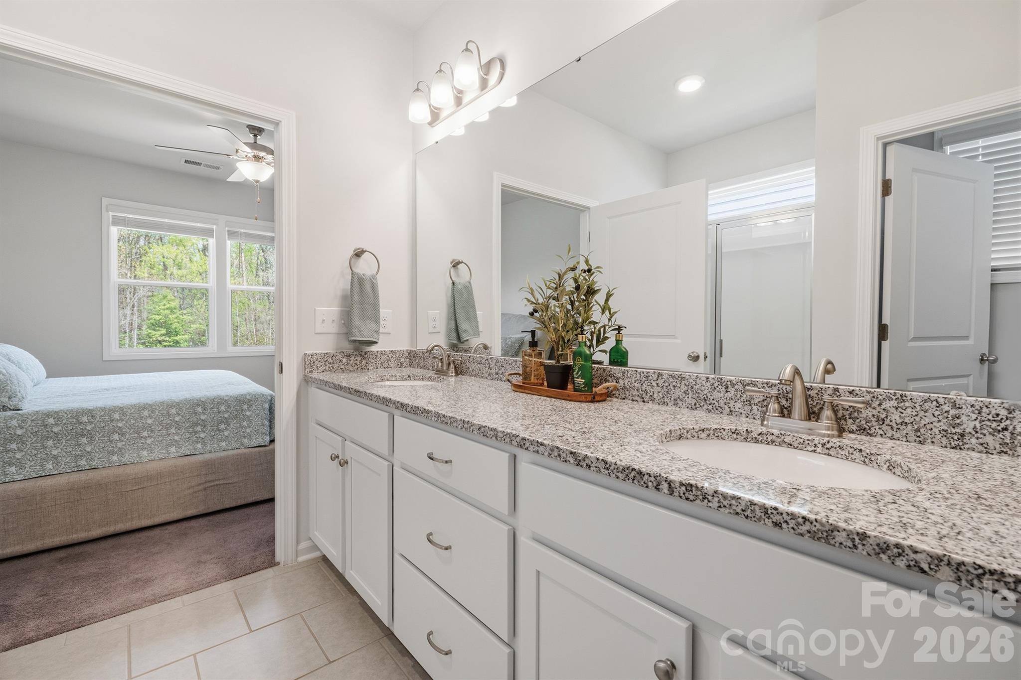 8220 Mccormick Street Terrell, NC 28682 - Photo 19 of 33 a bathroom with a granite countertop double vanity sink and a mirror
