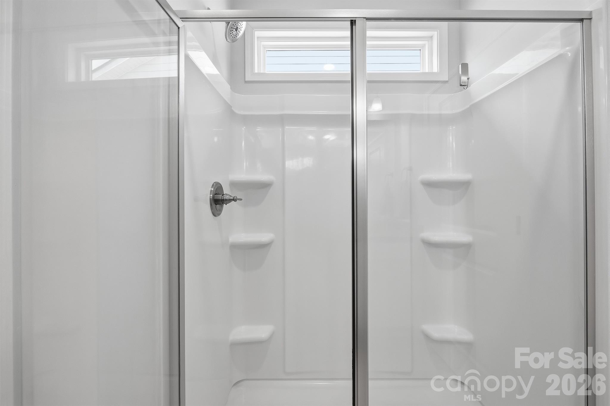 8220 Mccormick Street Terrell, NC 28682 - Photo 20 of 33 a bathroom with a glass shower door