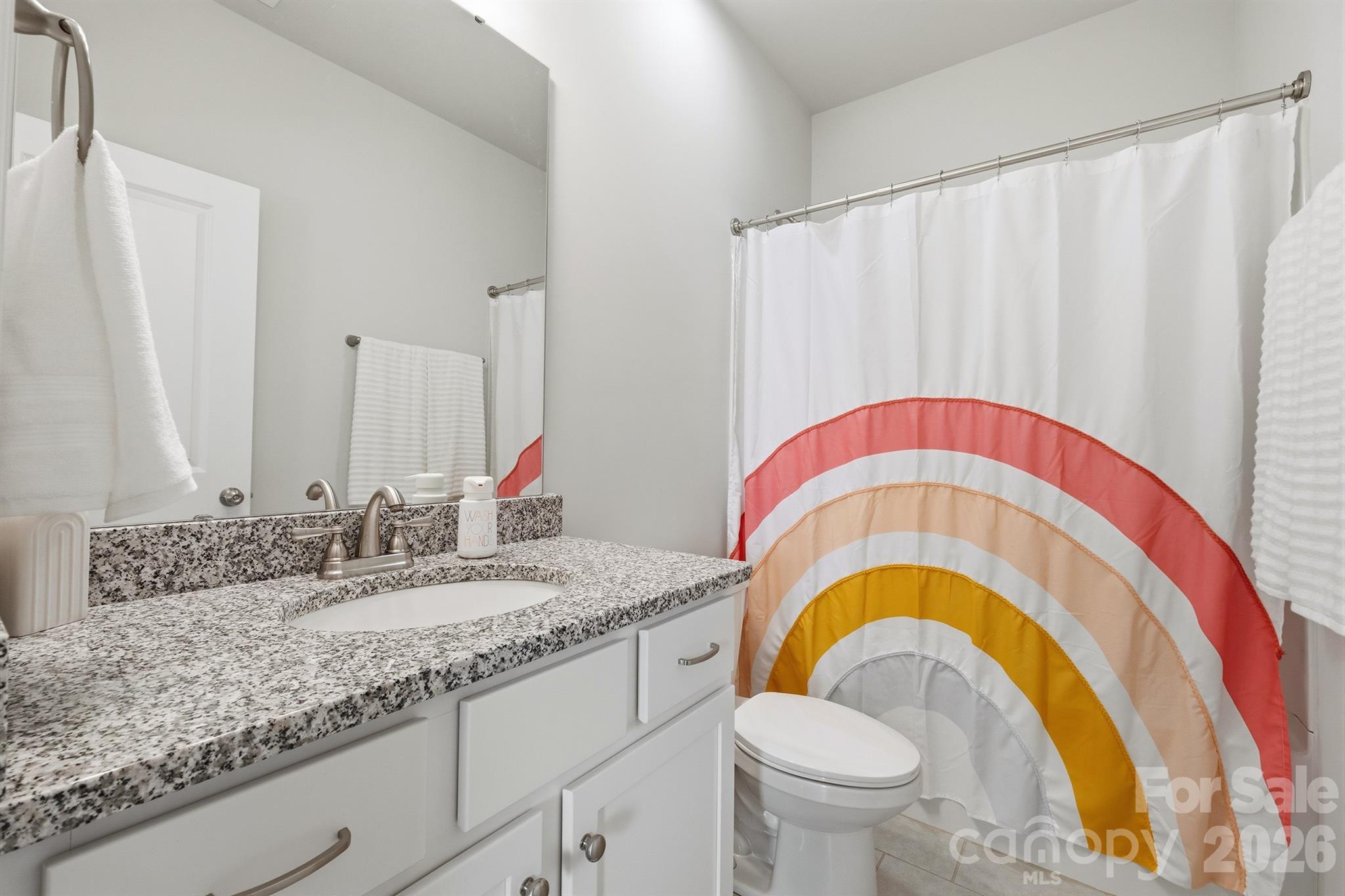 8220 Mccormick Street Terrell, NC 28682 - Photo 27 of 33 a bathroom with a sink a toilet and a mirror