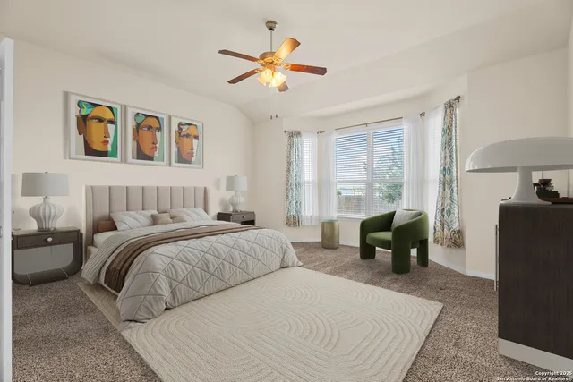 a bedroom with a large bed and a chandelier