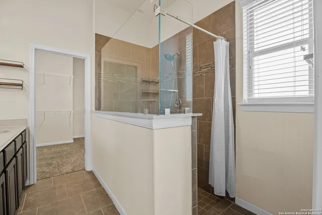 a bathroom with a shower and a sink
