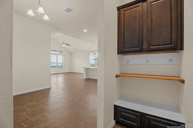 a view of a kitchen with wooden floor and cabinets