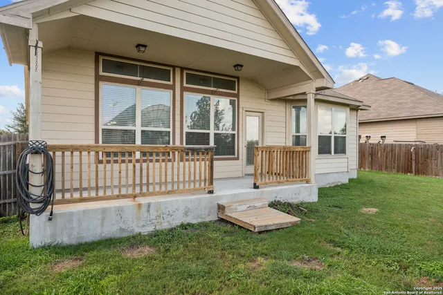 a view of a house with a yard and deck