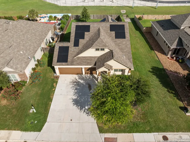 an aerial view of a house with a yard basket ball court and outdoor seating