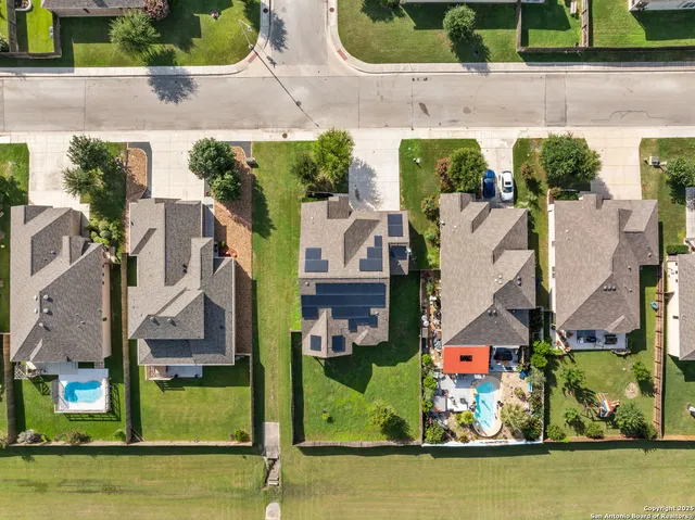 an aerial view of a house with a swimming pool