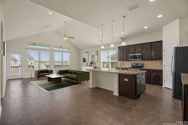 a large kitchen with stainless steel appliances kitchen island granite countertop a large counter top stainless steel appliances and cabinets