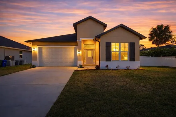 a front view of a house with a yard and garage