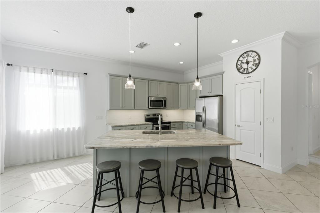 4437 Meridian Road Venice, FL 34293 - Photo 14 of 37 a kitchen with a table and chairs in it