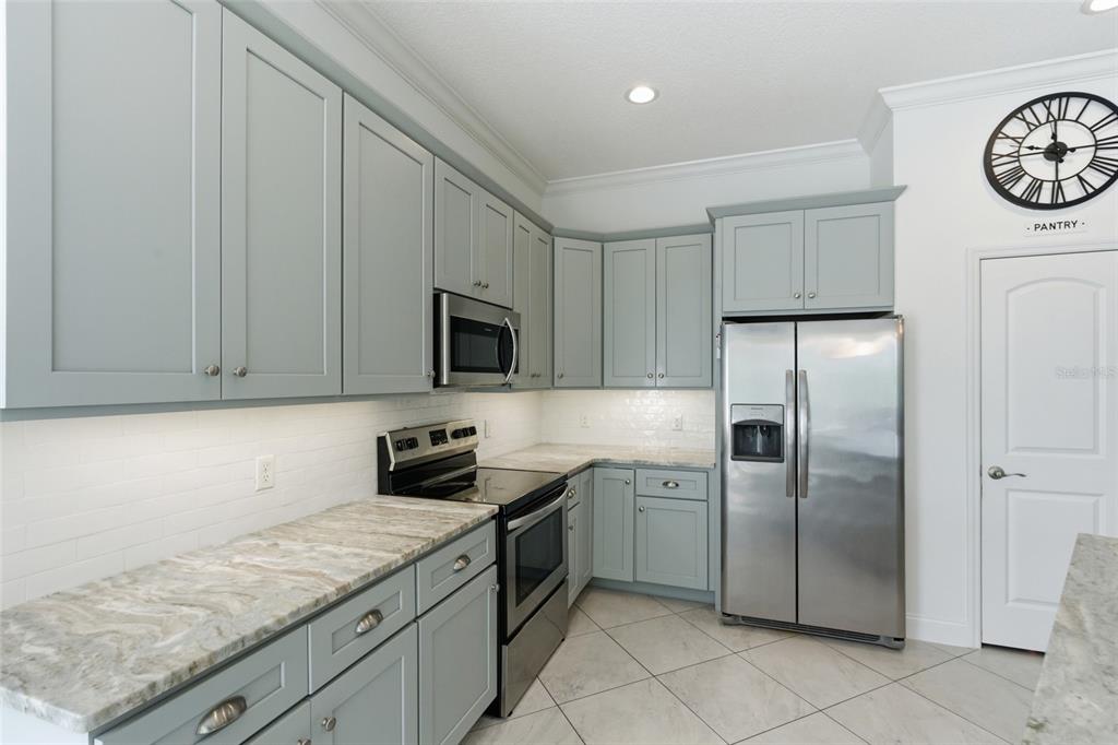 4437 Meridian Road Venice, FL 34293 - Photo 15 of 37 a kitchen with a refrigerator sink and cabinets