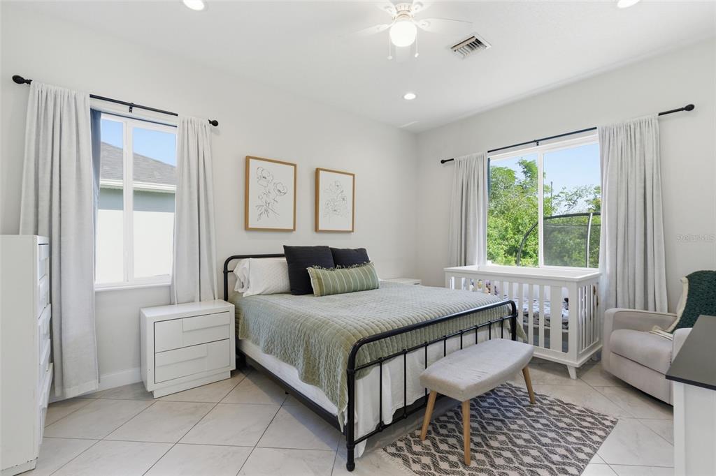 4437 Meridian Road Venice, FL 34293 - Photo 20 of 37 a bedroom with a bed and a couch