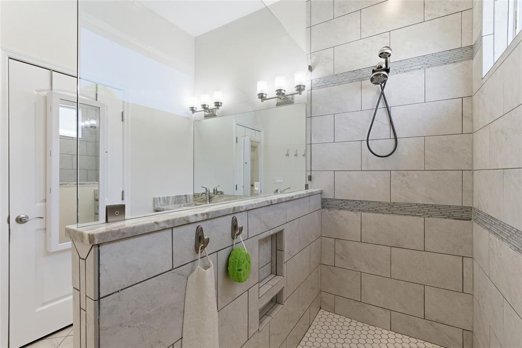 4437 Meridian Road Venice, FL 34293 - Photo 24 of 37 a bathroom with a double vanity sink and mirror