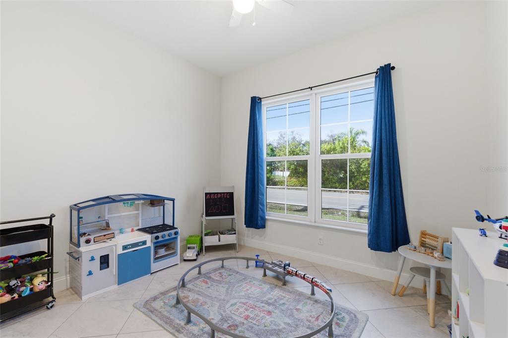 4437 Meridian Road Venice, FL 34293 - Photo 25 of 37 a living room with furniture and a large window