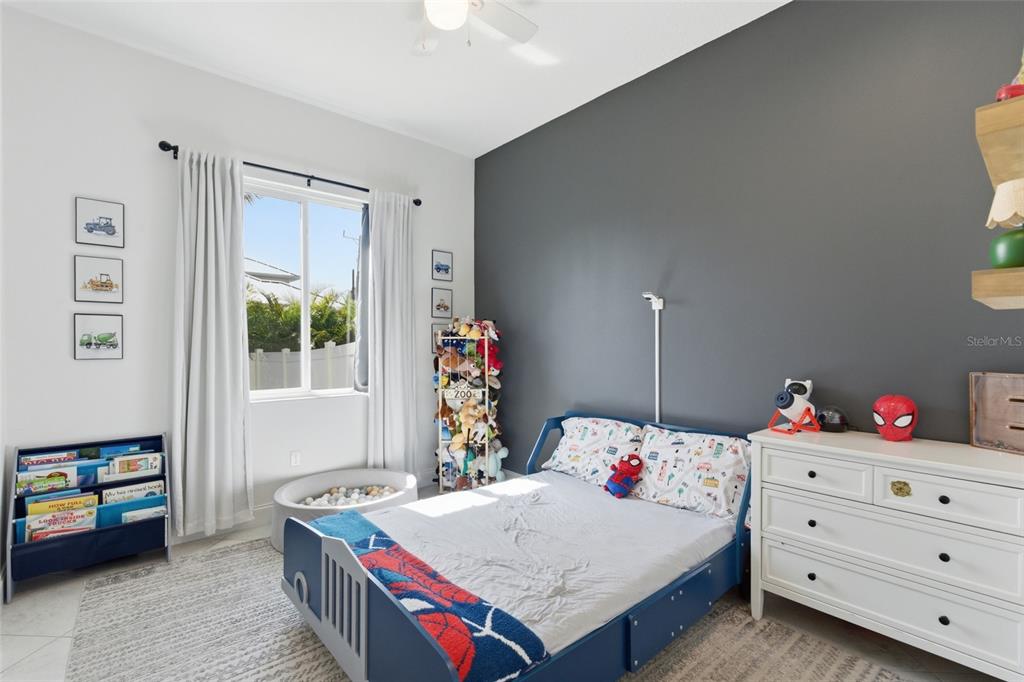 4437 Meridian Road Venice, FL 34293 - Photo 28 of 37 a bedroom with a bed a dresser and next to a window