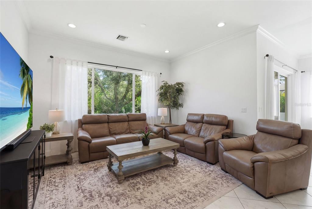 4437 Meridian Road Venice, FL 34293 - Photo 5 of 37 a living room with furniture flat screen tv and a large window