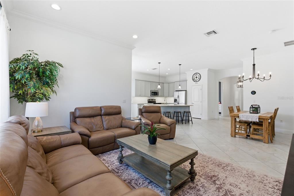 4437 Meridian Road Venice, FL 34293 - Photo 7 of 37 a living room with furniture and a fireplace
