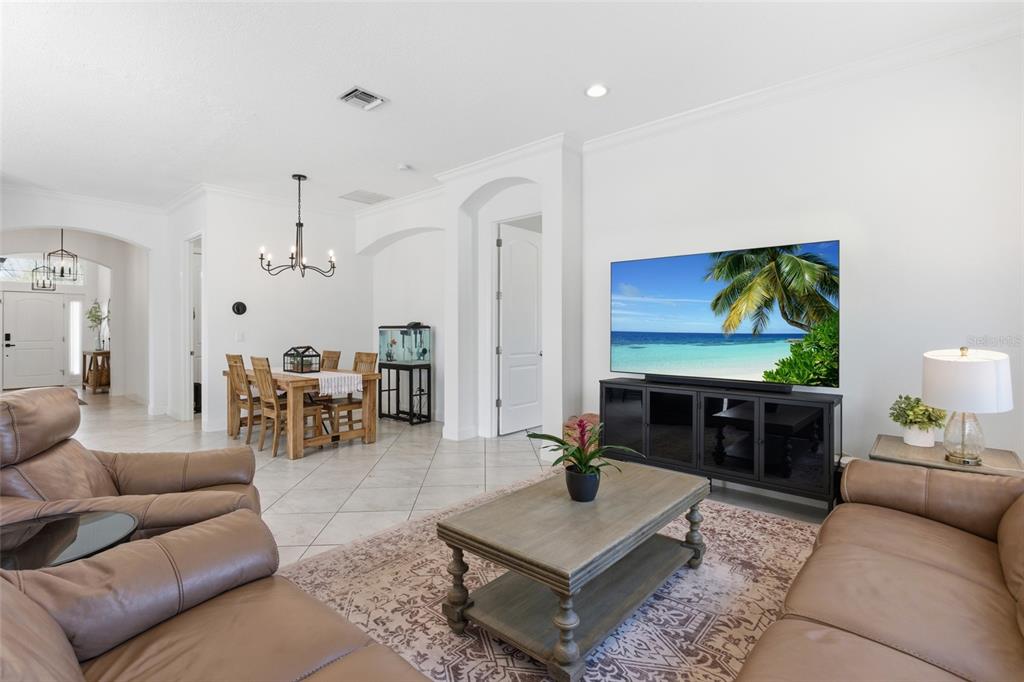 4437 Meridian Road Venice, FL 34293 - Photo 8 of 37 a living room with furniture a rug and a flat screen tv