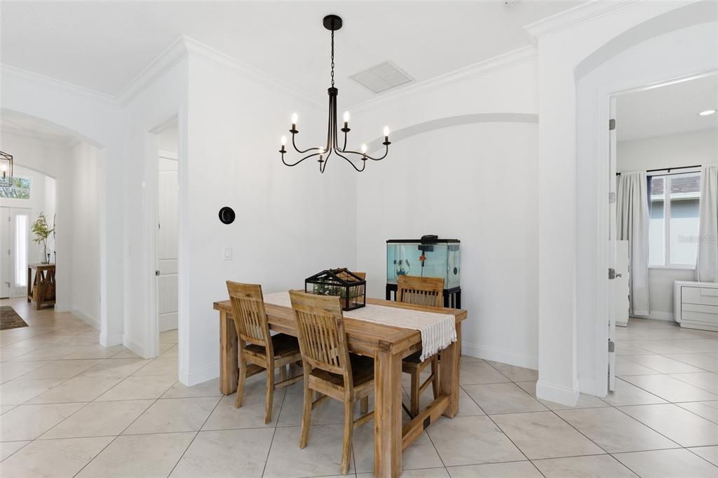 4437 Meridian Road Venice, FL 34293 - Photo 10 of 37 a dining room with furniture and window