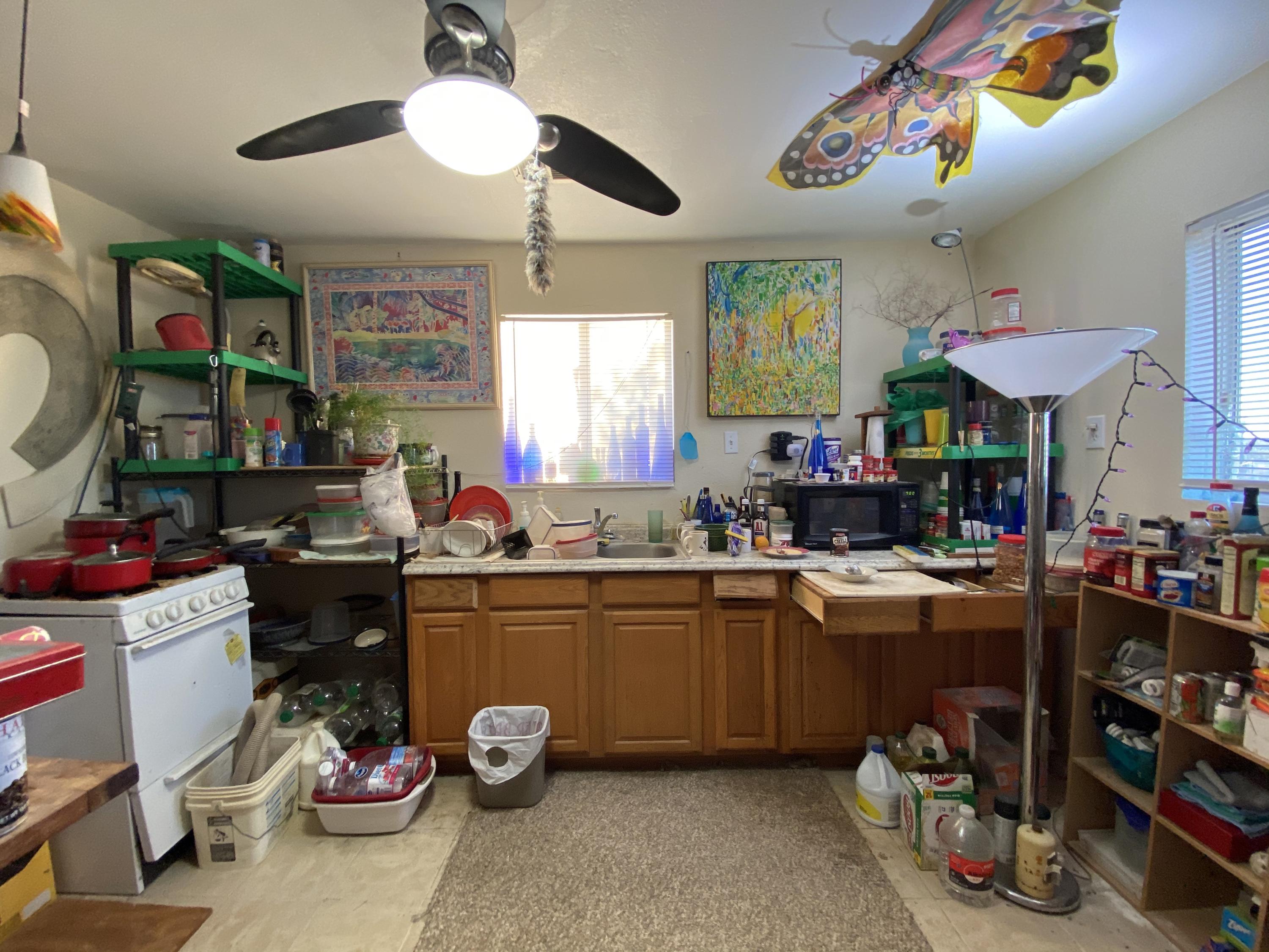 66855 Winters Road Joshua Tree, CA 92252 - Photo 10 of 19 a kitchen filled with a white stove top oven and a dining table
