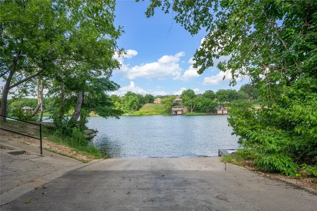 an aerial view of a house with a yard and lake view