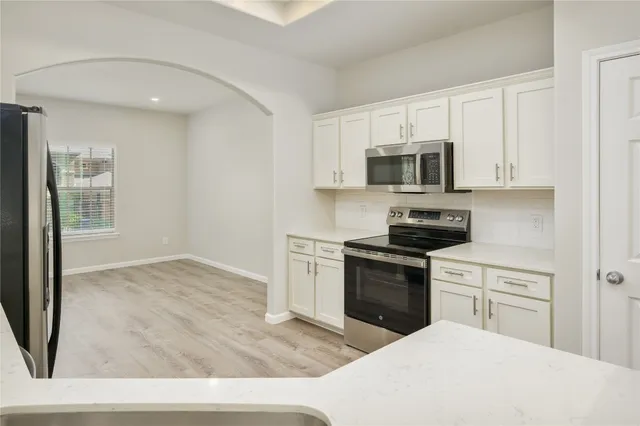 a kitchen with a stove top oven and sink