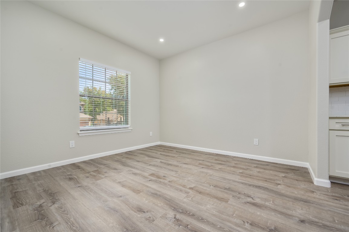2016 Whitebead Trail Austin, TX 78734 - Photo 6 of 31 an empty room with wooden floor and windows