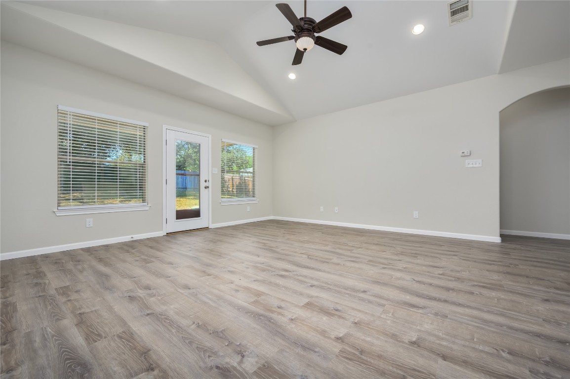 2016 Whitebead Trail Austin, TX 78734 - Photo 8 of 31 an empty room with wooden floor fan and windows