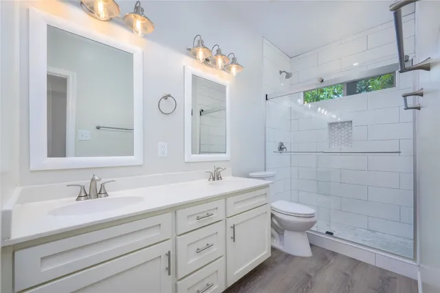 a bathroom with a double vanity sink mirror double and shower