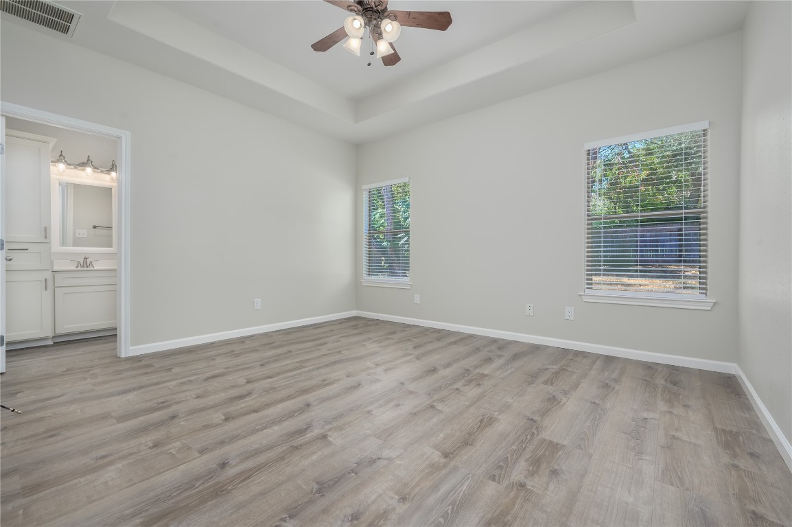 2016 Whitebead Trail Austin, TX 78734 - Photo 10 of 31 an empty room with wooden floor chandelier fan and windows